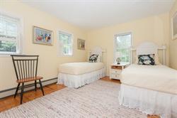 608 Old Post Road Cotuit, MA 02635 - Photo 26 of 30 a spacious bedroom with a bed and a table