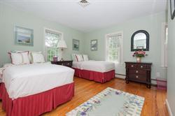 608 Old Post Road Cotuit, MA 02635 - Photo 27 of 30 a bedroom with bed and wooden floor
