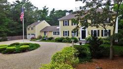 608 Old Post Road Cotuit, MA 02635 - Photo 10 of 30 a front view of a house with a garden and trees