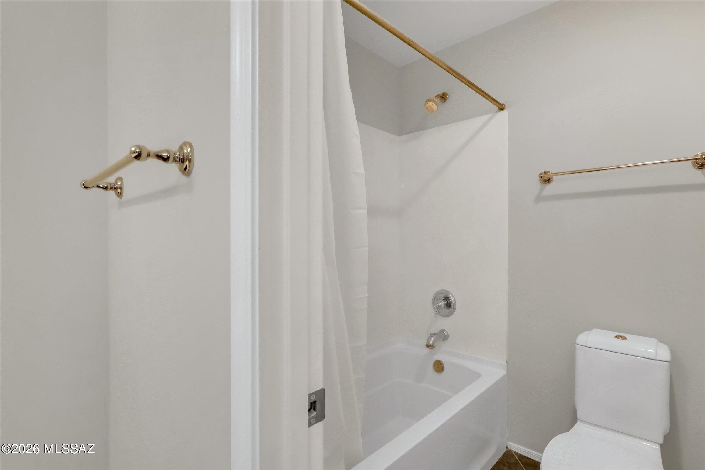 6095 South Jakemp Trail Tucson, AZ 85747 - Photo 36 of 52 a bathroom with a shower a toilet and a shower