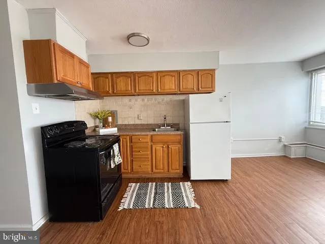 a kitchen with a refrigerator and a stove