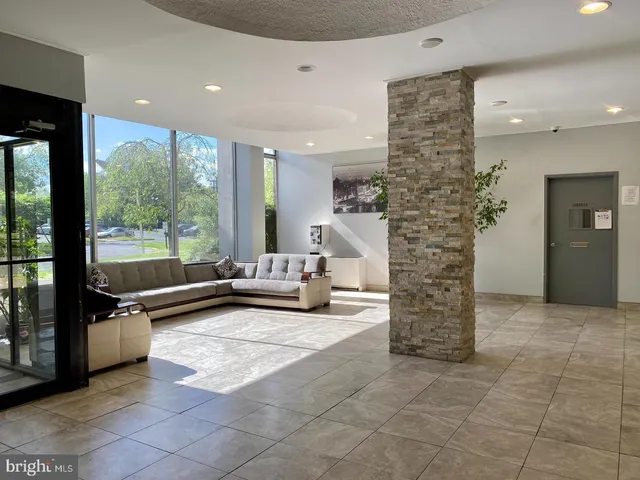 a living room with fireplace furniture and a floor to ceiling window