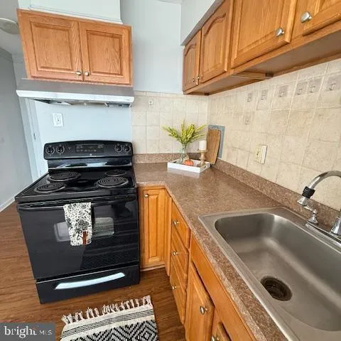 a kitchen with stainless steel appliances granite countertop a stove and a sink