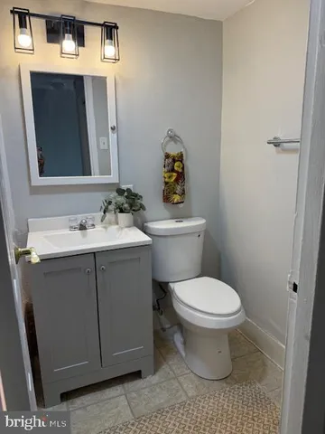a bathroom with a sink toilet and mirror