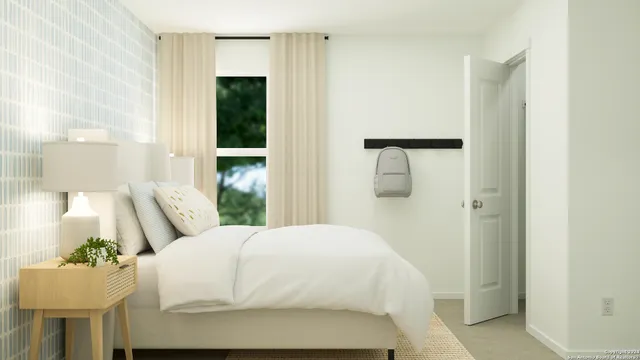 a bedroom with a bed and a painting on the wall