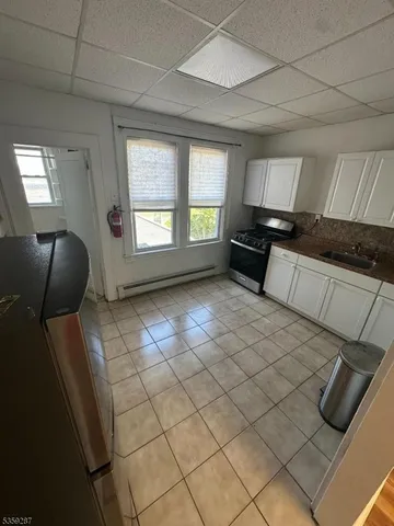 a open kitchen with cabinets and a wooden floor