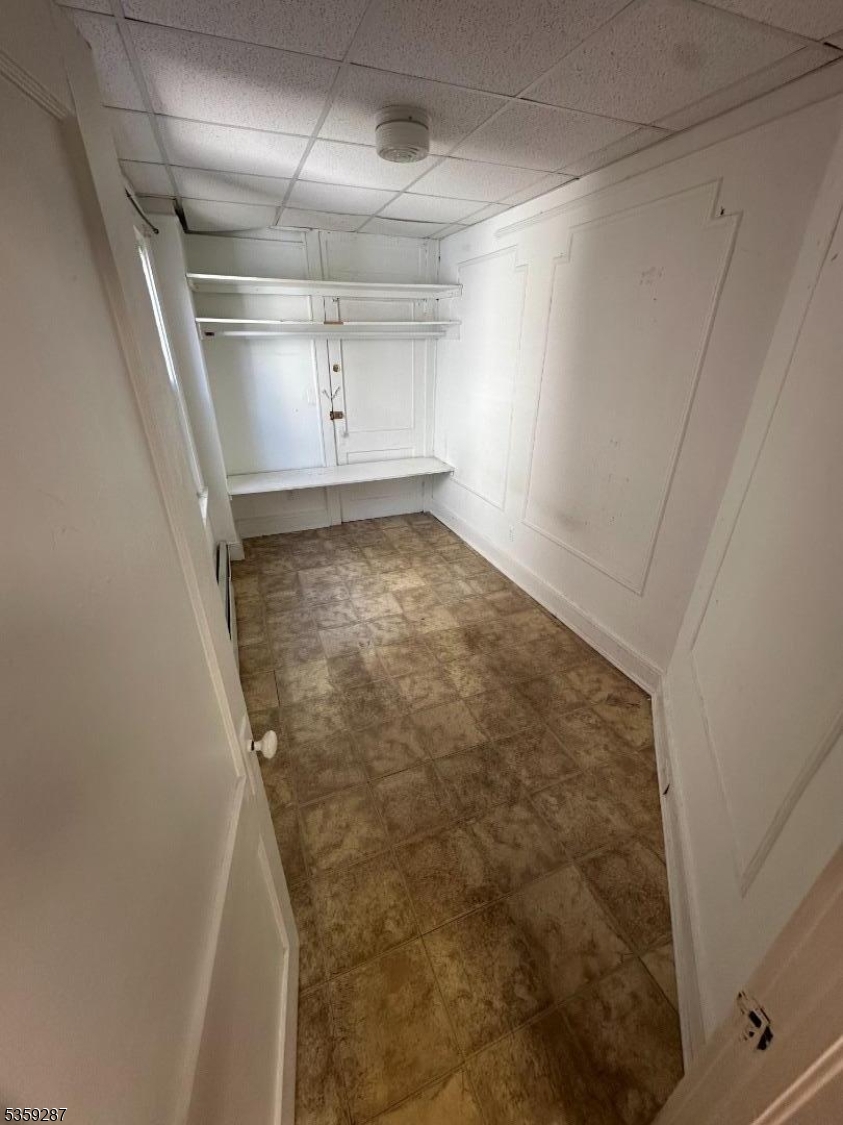 1153 Main Avenue Clifton, NJ 07011 - Photo 4 of 6 a view of a room with racks on the wall