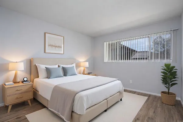 a bedroom with bed and a potted plant