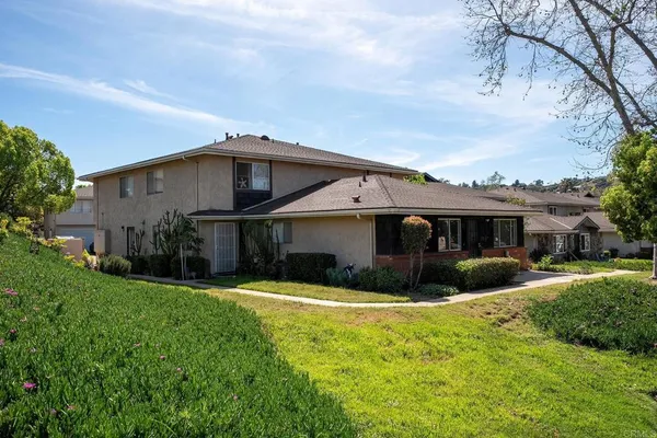 a view of house with yard and green space