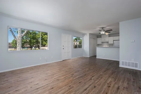 wooden floor in an empty room with a window