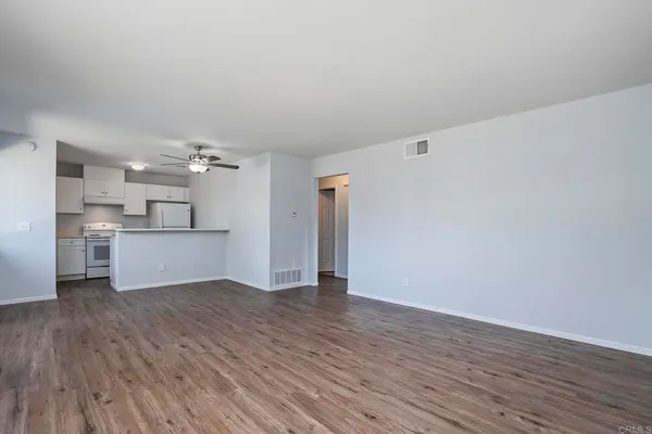 a view of a kitchen with wooden floor and a kitchen