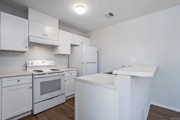 a kitchen with a sink a stove and refrigerator