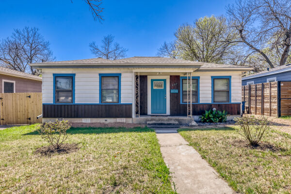 a front view of a house with a yard and porch