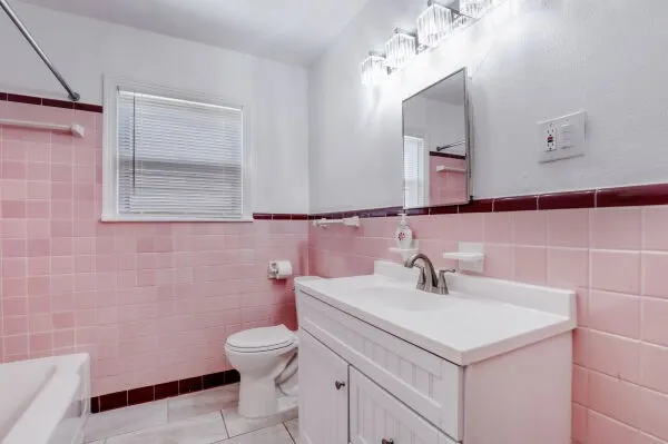 a bathroom with a sink a toilet and mirror