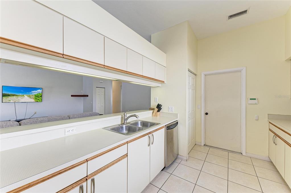 5045 82nd Way East Sarasota, FL 34243 - Photo 13 of 34 a kitchen with a sink and cabinets