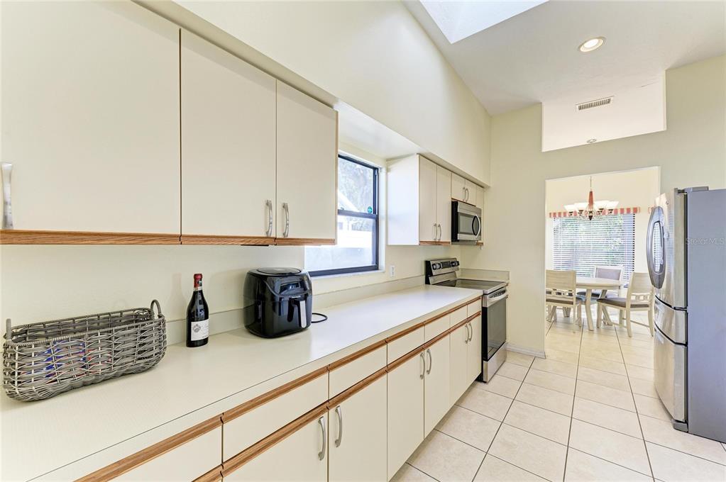 5045 82nd Way East Sarasota, FL 34243 - Photo 14 of 34 a kitchen with stainless steel appliances a sink a stove and cabinets