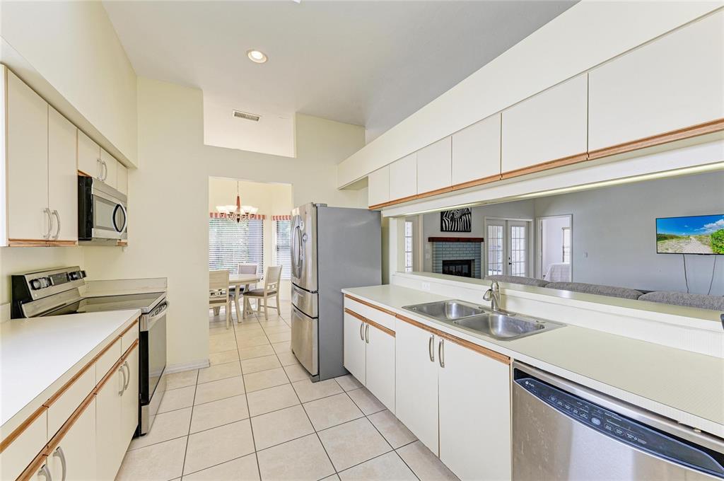 5045 82nd Way East Sarasota, FL 34243 - Photo 15 of 34 a kitchen with a sink stove and cabinets