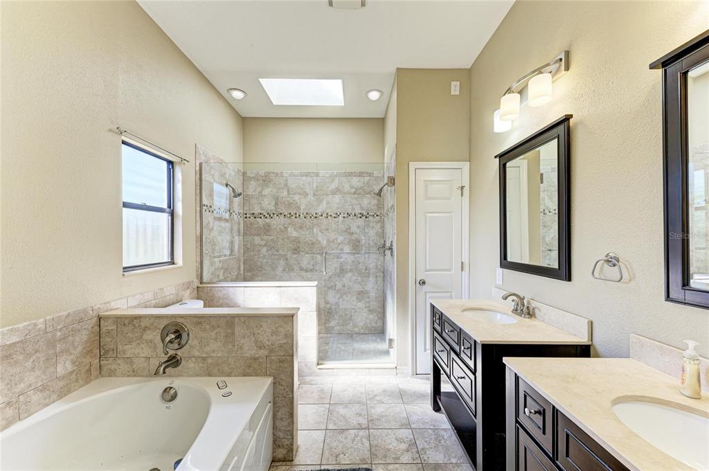 5045 82nd Way East Sarasota, FL 34243 - Photo 20 of 34 a bathroom with a tub sink and mirror