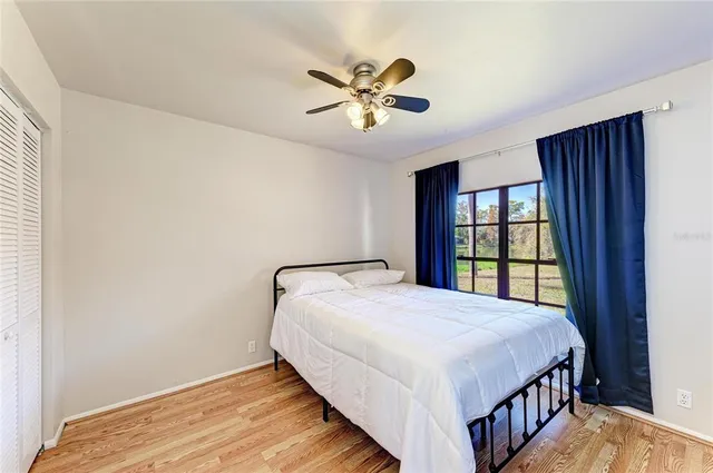 a bedroom with a large bed and a window