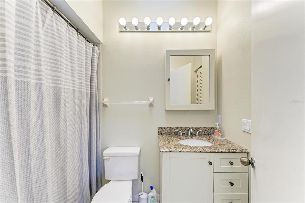 5045 82nd Way East Sarasota, FL 34243 - Photo 25 of 34 a bathroom with a granite countertop sink and a mirror