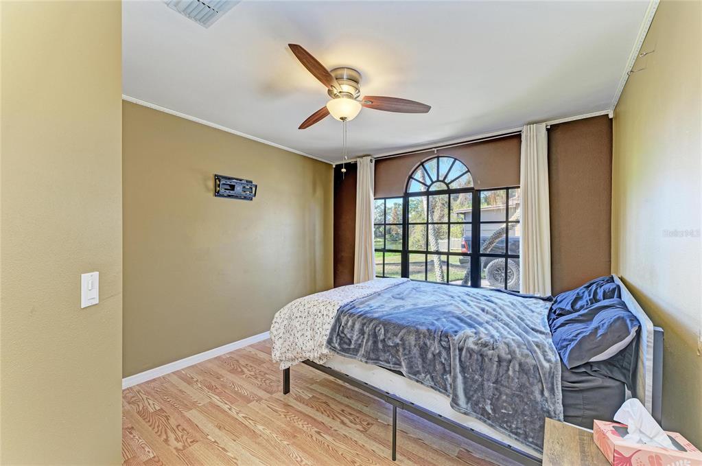 5045 82nd Way East Sarasota, FL 34243 - Photo 26 of 34 a bedroom with a bed and a large window