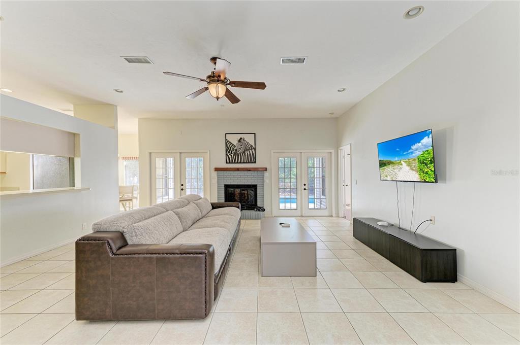 5045 82nd Way East Sarasota, FL 34243 - Photo 5 of 34 a living room with furniture and a fireplace