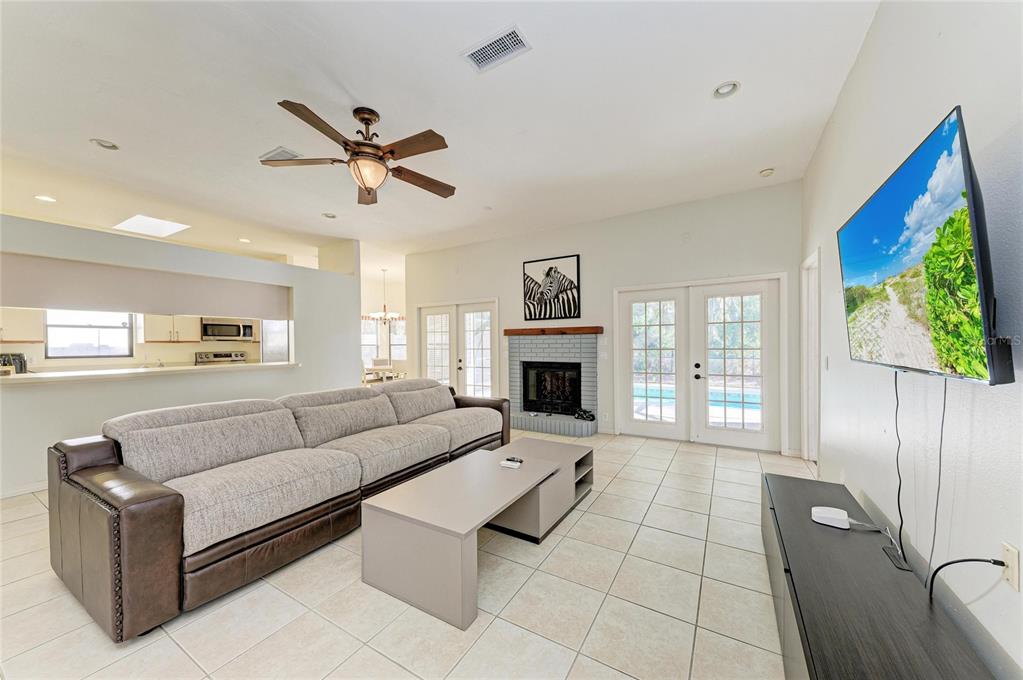5045 82nd Way East Sarasota, FL 34243 - Photo 6 of 34 a living room with furniture and a fireplace