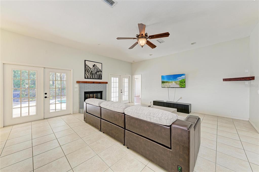 5045 82nd Way East Sarasota, FL 34243 - Photo 7 of 34 a living room with furniture and a fireplace