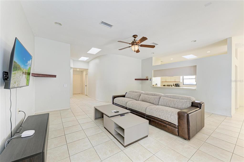 5045 82nd Way East Sarasota, FL 34243 - Photo 9 of 34 a living room with furniture and a flat screen tv