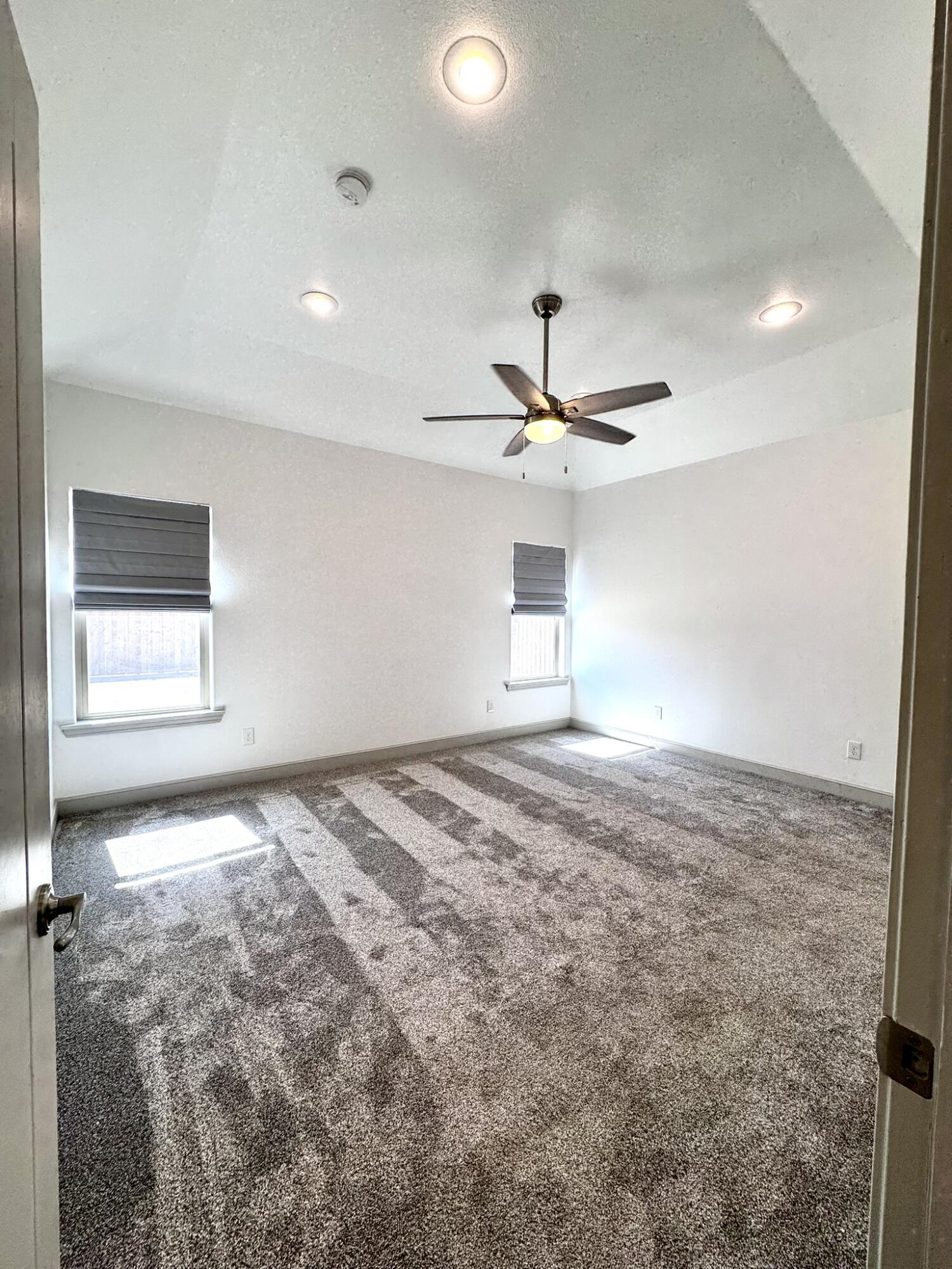 5615 115th Street Lubbock, TX 79424 - Photo 12 of 31 a view of a livingroom with a ceiling fan and window