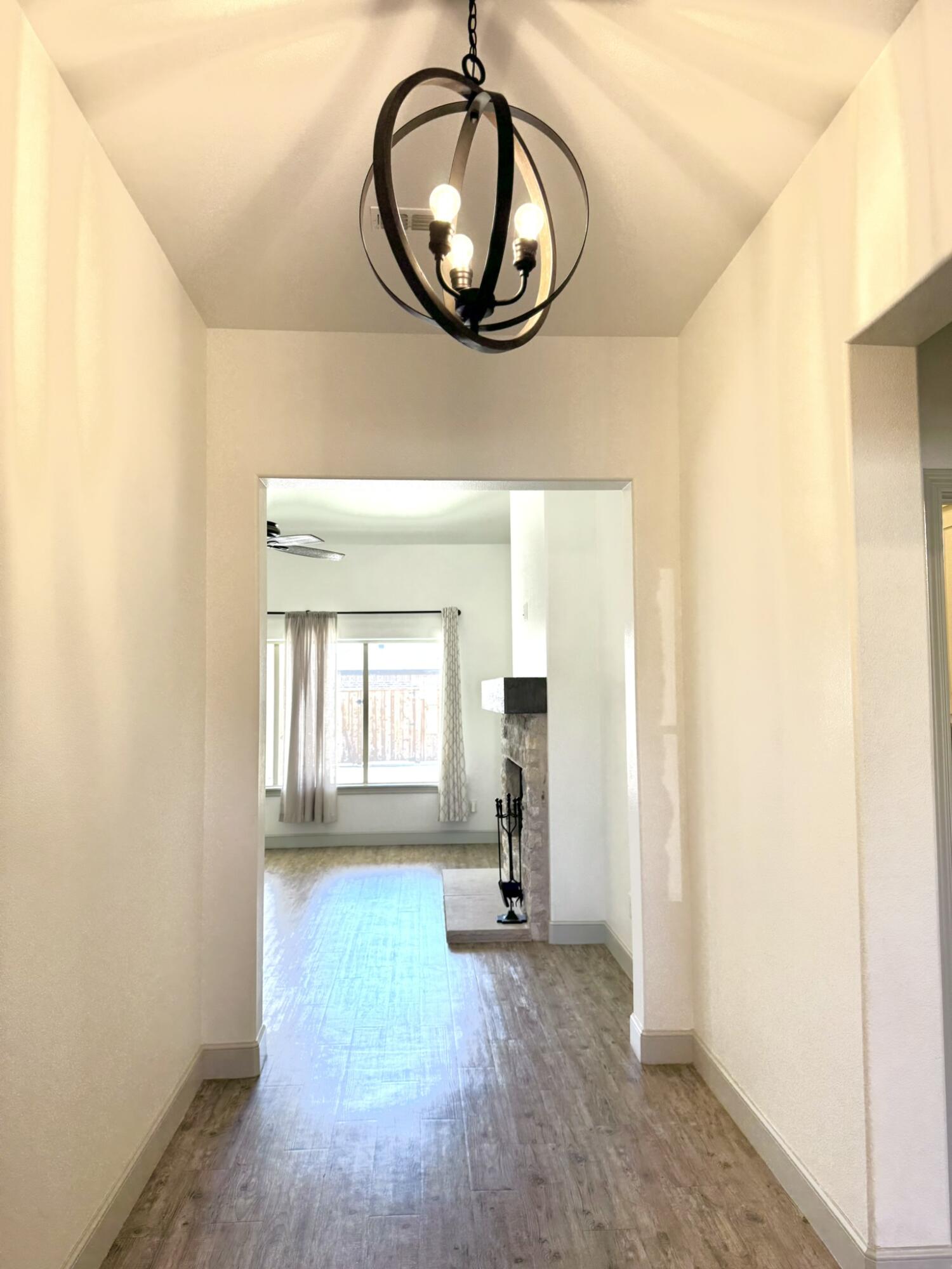 5615 115th Street Lubbock, TX 79424 - Photo 3 of 31 a view of a hallway with wooden floor and a windows