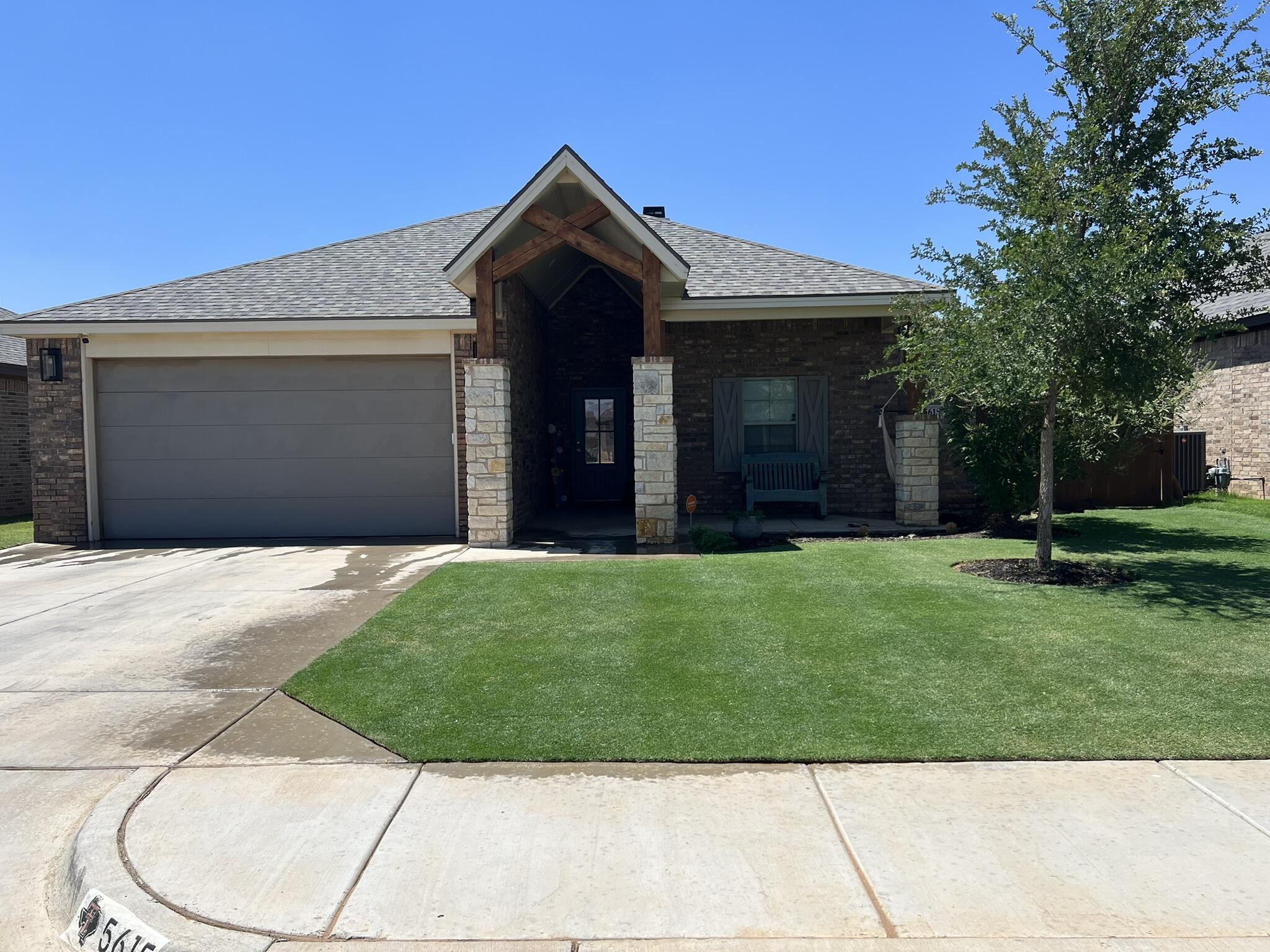 5615 115th Street Lubbock, TX 79424 - Photo 31 of 31 a front view of a house with a garden