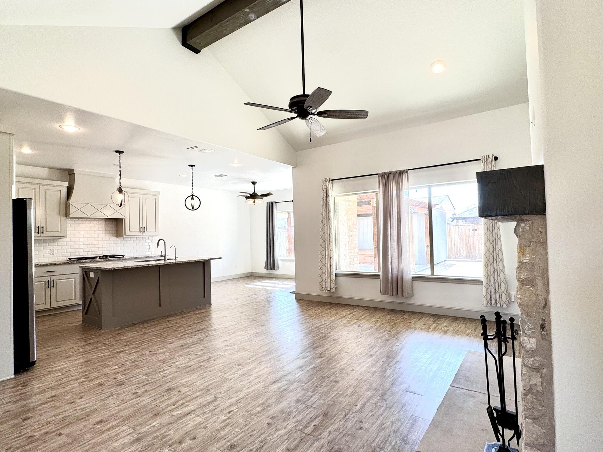 5615 115th Street Lubbock, TX 79424 - Photo 4 of 31 a large kitchen with cabinets a sink and a stove