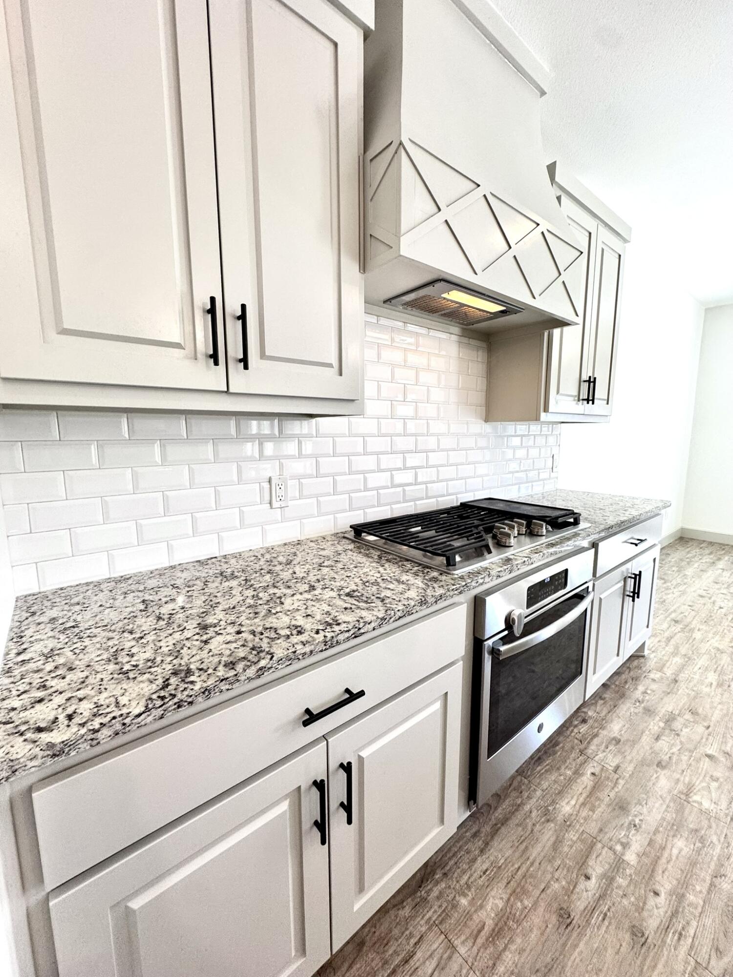 5615 115th Street Lubbock, TX 79424 - Photo 6 of 31 a kitchen with stainless steel appliances granite countertop a sink and a stove