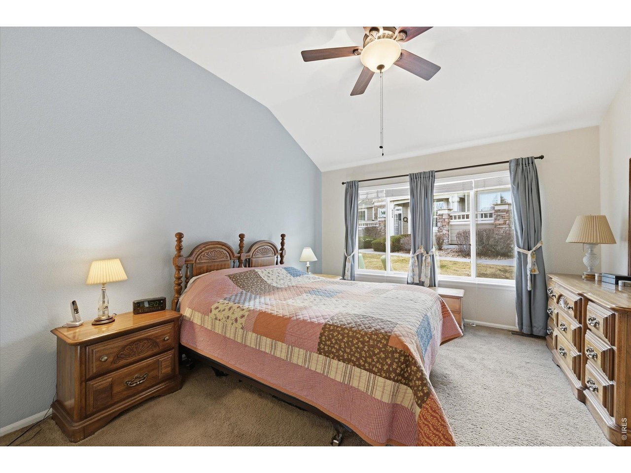 6227 Secrest Lane Arvada, CO 80403 - Photo 13 of 47 a spacious bedroom with a bed and a chandelier