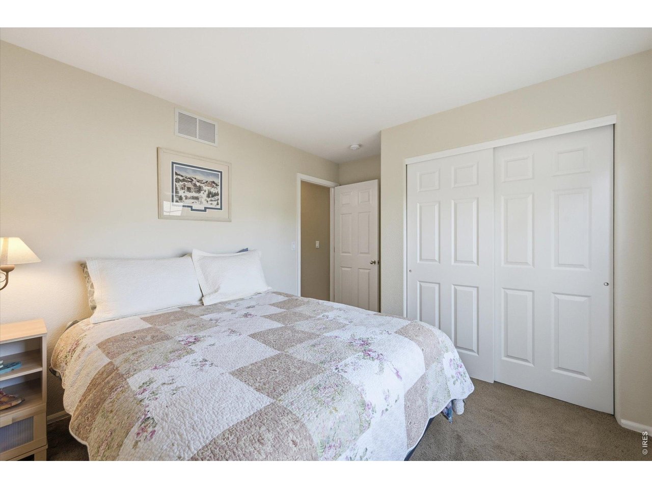 6227 Secrest Lane Arvada, CO 80403 - Photo 16 of 47 a bedroom with a bed and a painting on the wall