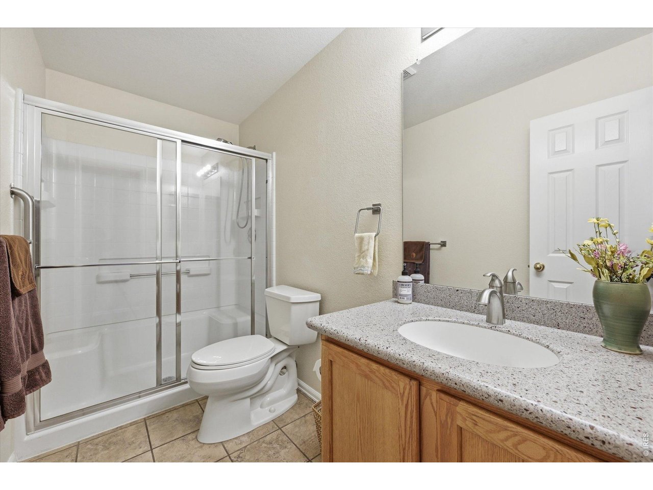 6227 Secrest Lane Arvada, CO 80403 - Photo 17 of 47 a bathroom with a granite countertop sink toilet and shower