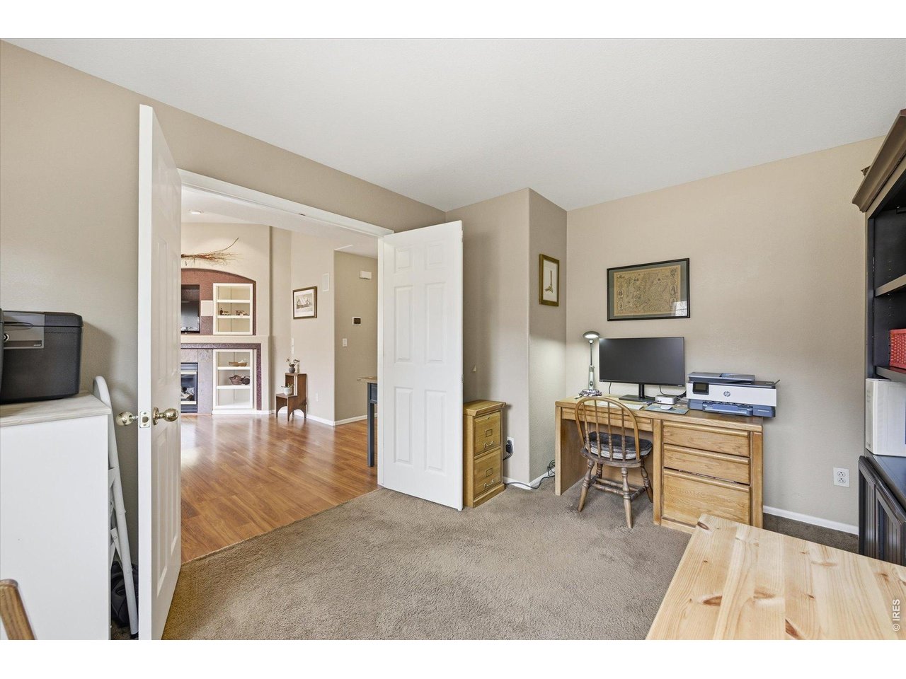 6227 Secrest Lane Arvada, CO 80403 - Photo 20 of 47 a living room with furniture a flat screen tv and a refrigerator