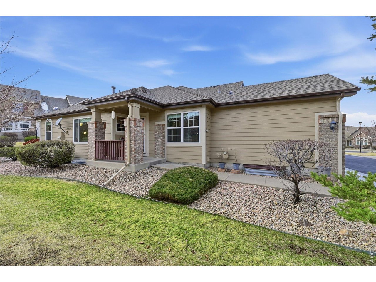 6227 Secrest Lane Arvada, CO 80403 - Photo 23 of 47 a front view of a house with a garden