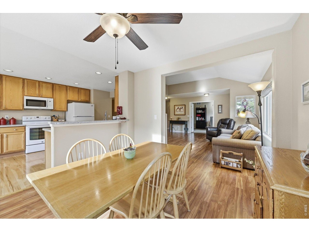 6227 Secrest Lane Arvada, CO 80403 - Photo 25 of 47 a living room with stainless steel appliances granite countertop furniture a fireplace a flat screen tv and a window