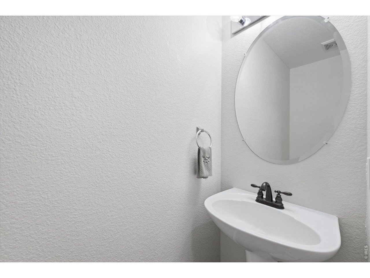 6227 Secrest Lane Arvada, CO 80403 - Photo 28 of 47 a bathroom with a sink mirror and vanity