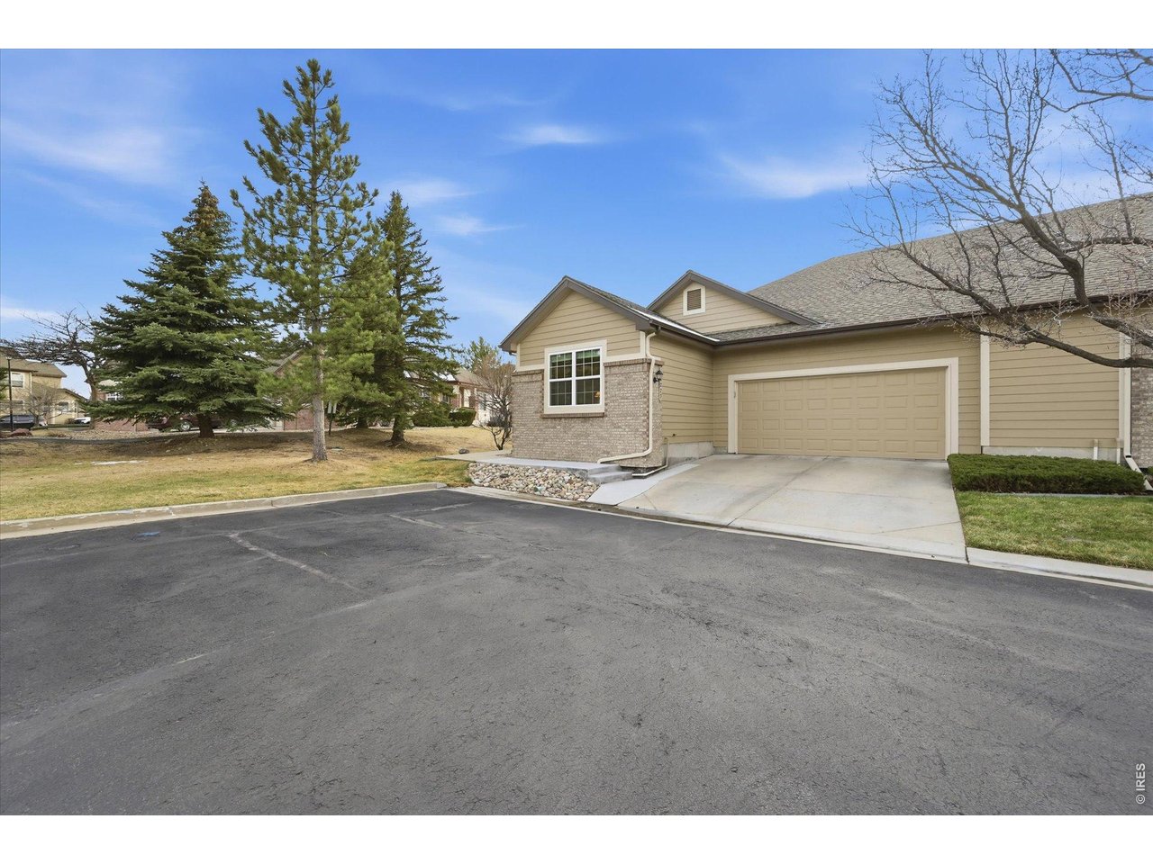 6227 Secrest Lane Arvada, CO 80403 - Photo 32 of 47 a front view of a house with a yard and garage