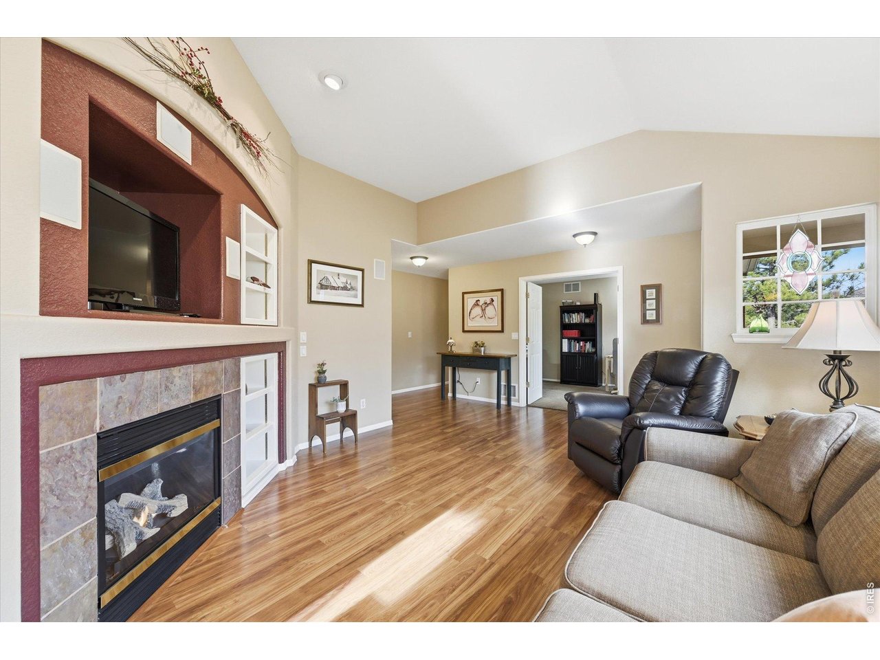 6227 Secrest Lane Arvada, CO 80403 - Photo 4 of 47 a living room with furniture a flat screen tv and a fireplace