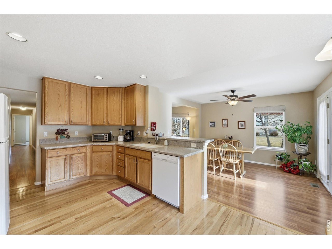 6227 Secrest Lane Arvada, CO 80403 - Photo 8 of 47 a kitchen with a sink cabinets and wooden floor
