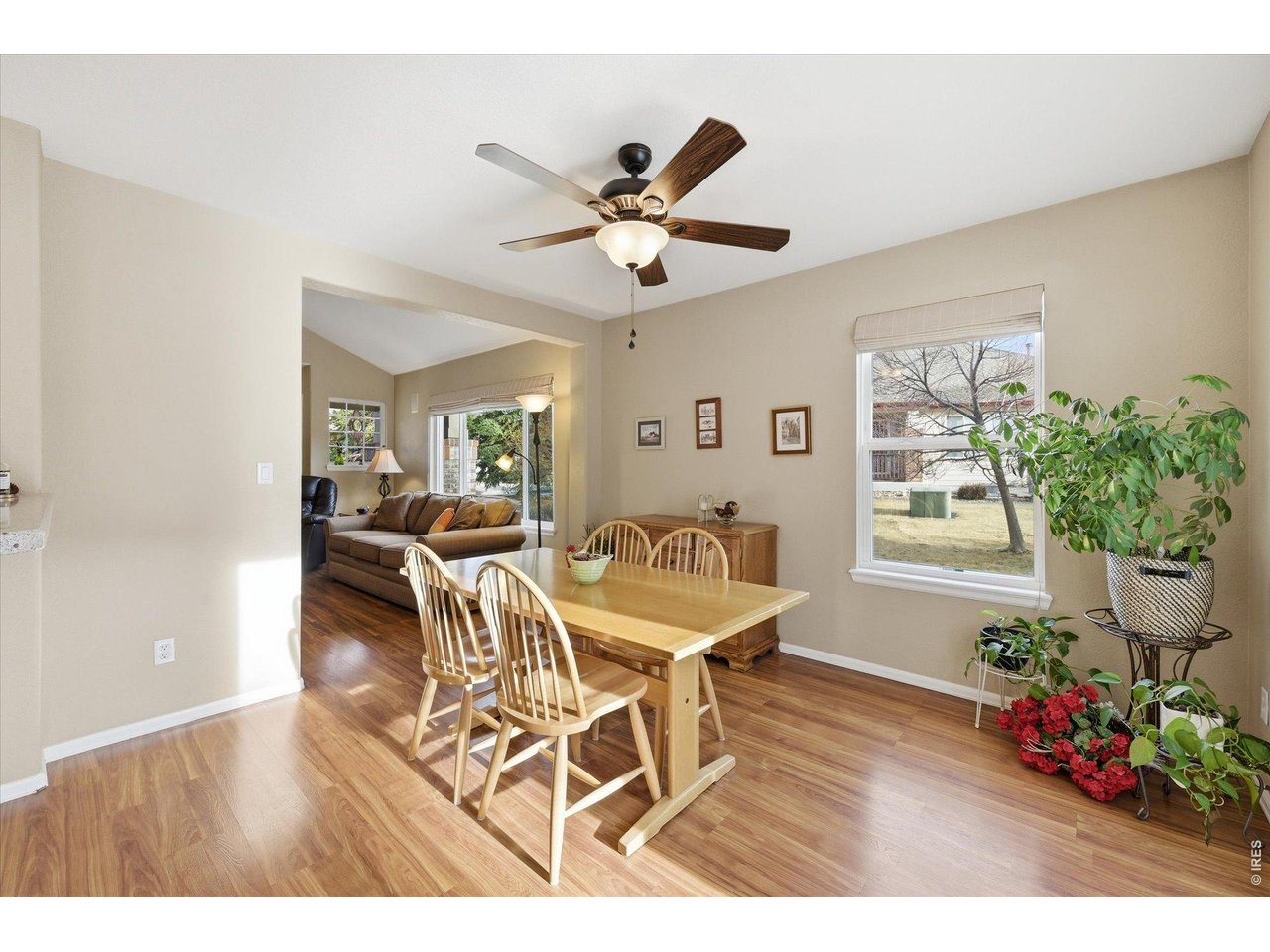6227 Secrest Lane Arvada, CO 80403 - Photo 9 of 47 a dining room with furniture potted plants and wooden floor