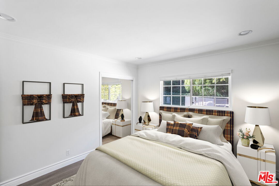 16636 Calneva Drive Encino, CA 91436 - Photo 8 of 18 a bedroom with a large bed and a window