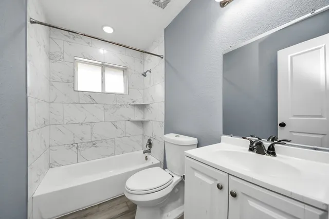 a bathroom with a sink toilet and bathtub
