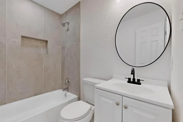 a bathroom with a sink a mirror and a toilet