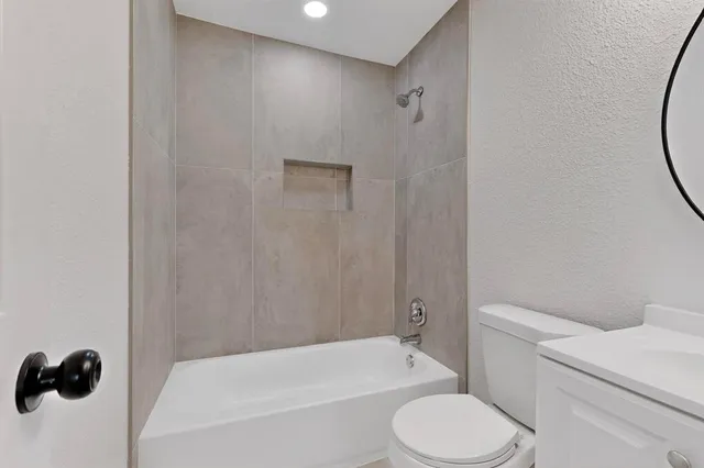 a bathroom with a toilet and a bath tub