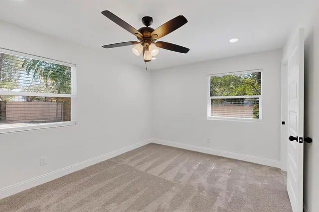 a view of room with window and ceiling fan